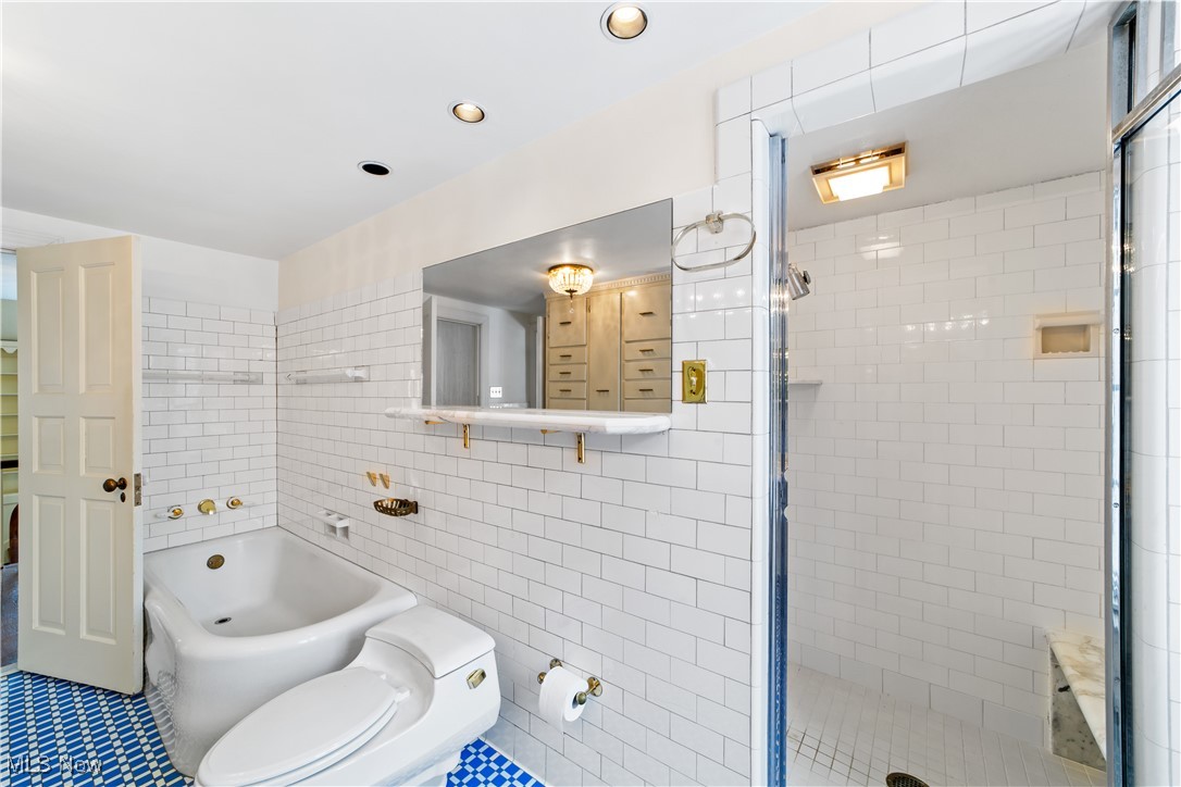 2995 Brighton Road Cleveland, OH 44120 - Photo 20 of 39 Full bathroom with toilet, recessed lighting, tile walls, a shower stall, and a tub
