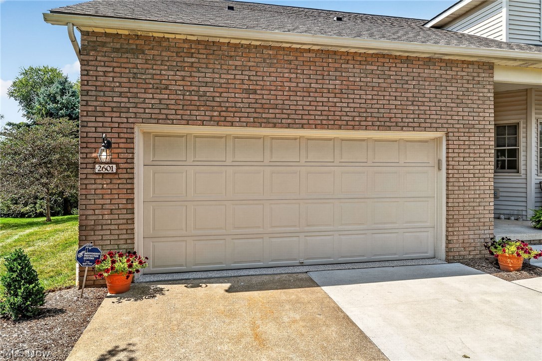 2601 Charing Cross Road Northwest Canton, OH 44708 - Photo 40 of 49 Brick exterior with an attached garage and concrete driveway