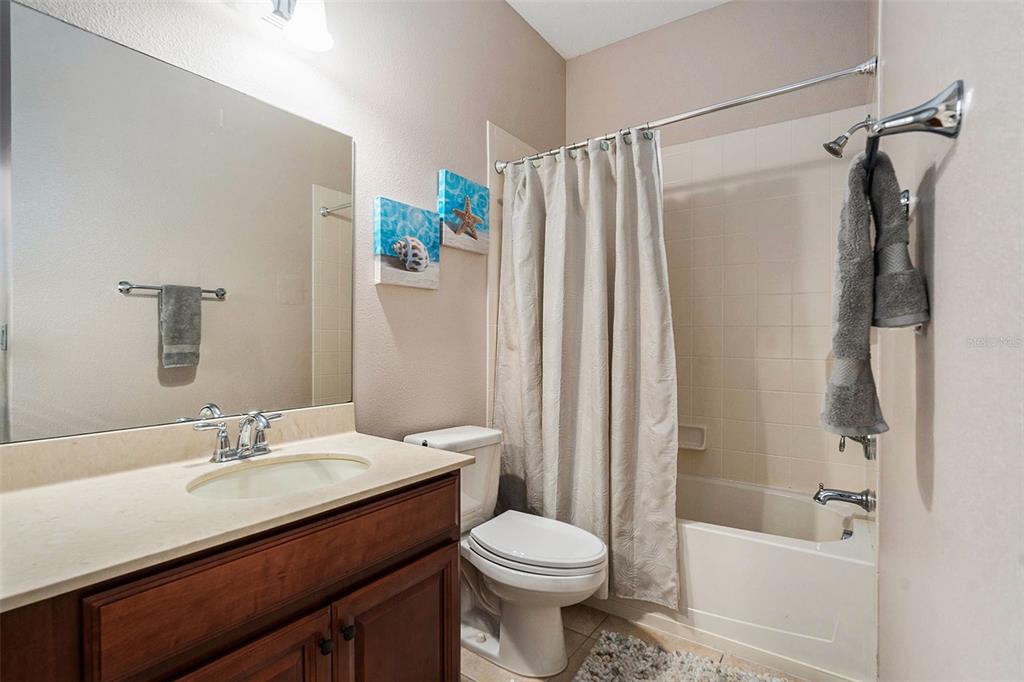 10737 Breaking Rocks Drive Tampa, FL 33647 - Photo 12 of 28 a bathroom with a sink a toilet and shower