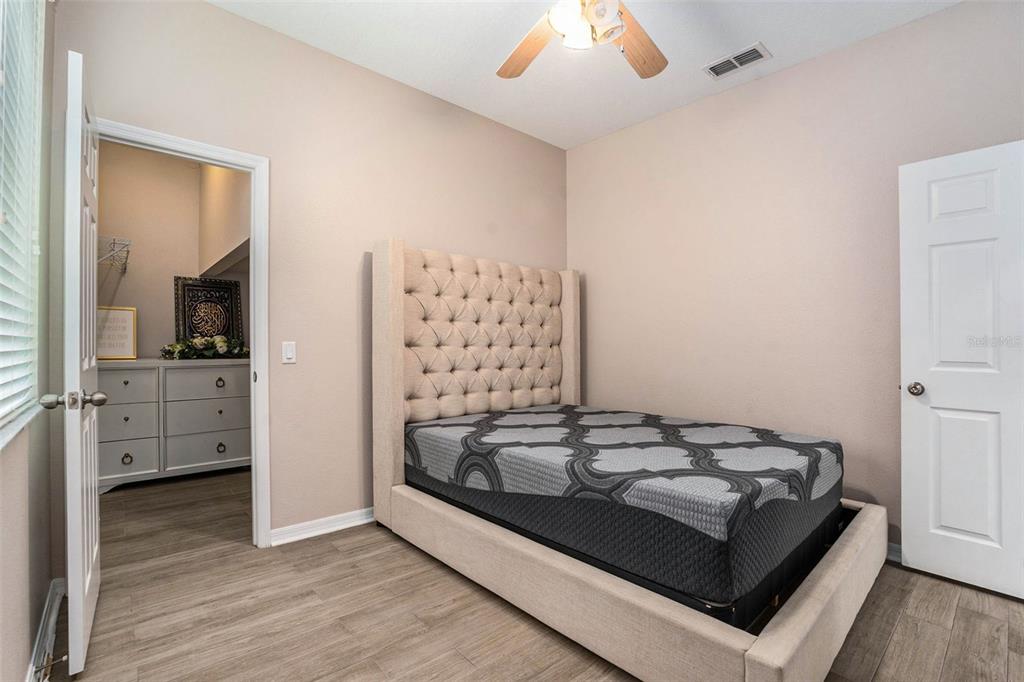 10737 Breaking Rocks Drive Tampa, FL 33647 - Photo 14 of 28 a view of bedroom with furniture and wooden floor