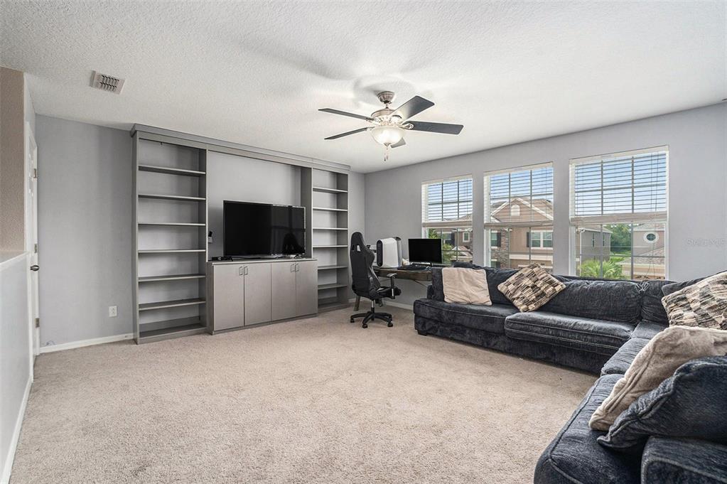 10737 Breaking Rocks Drive Tampa, FL 33647 - Photo 16 of 28 a living room with furniture and a flat screen tv