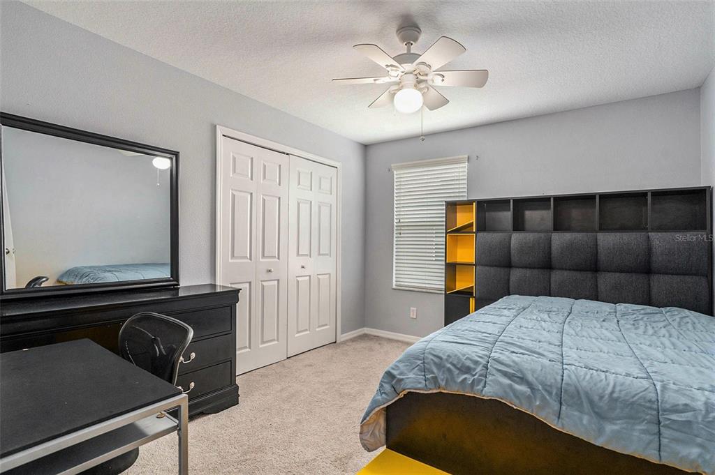 10737 Breaking Rocks Drive Tampa, FL 33647 - Photo 20 of 28 a bedroom with a bed and a chandelier