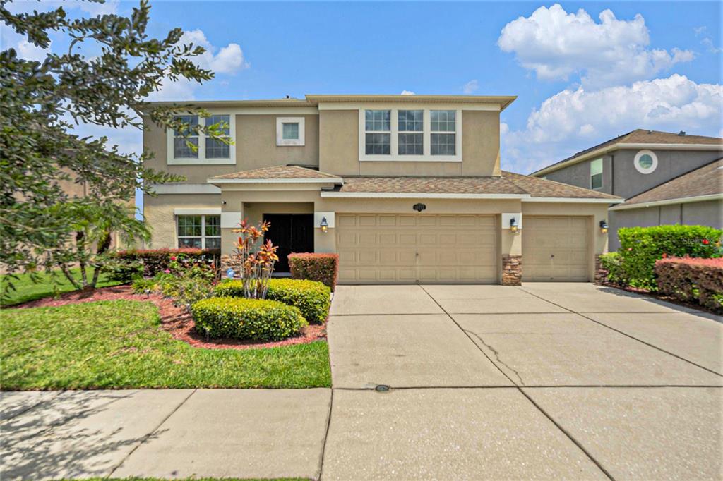10737 Breaking Rocks Drive Tampa, FL 33647 - Photo 2 of 28 a front view of a house with porch and chairs