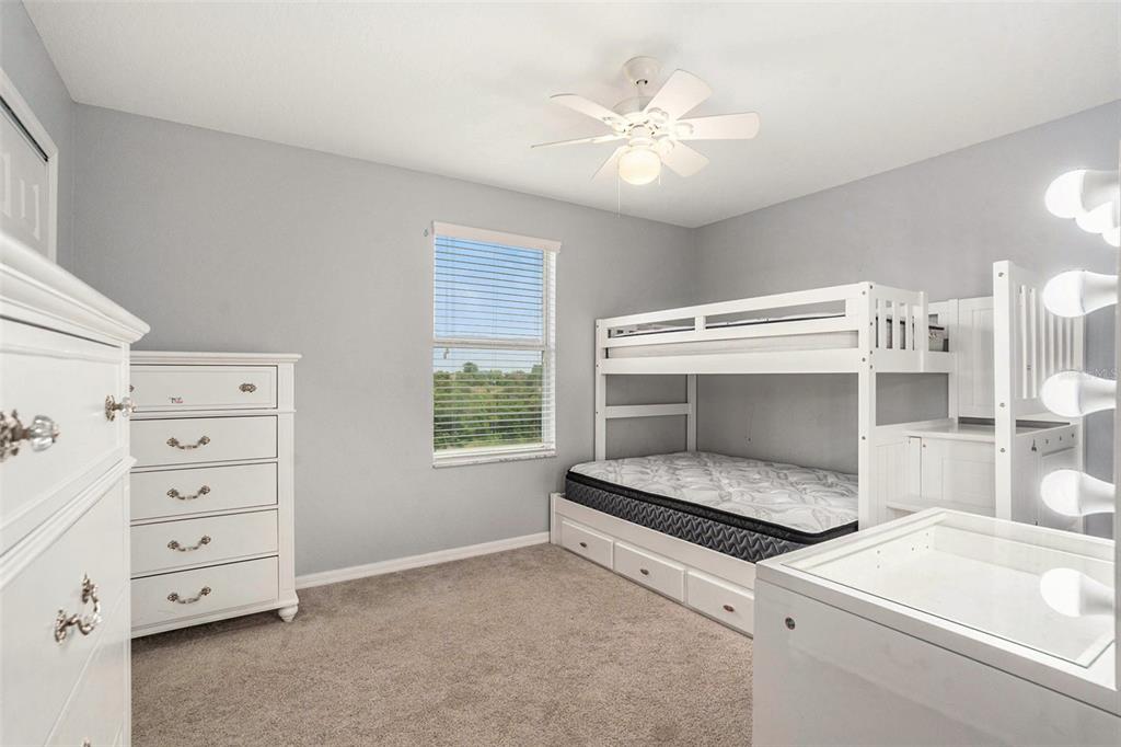 10737 Breaking Rocks Drive Tampa, FL 33647 - Photo 21 of 28 a bedroom with a bed and a cabinets