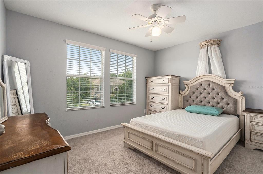 10737 Breaking Rocks Drive Tampa, FL 33647 - Photo 22 of 28 a bedroom with a bed and a couch