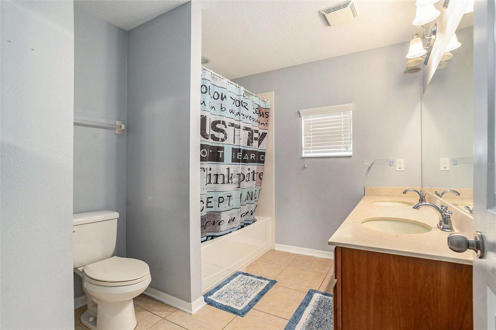 10737 Breaking Rocks Drive Tampa, FL 33647 - Photo 23 of 28 a bathroom with a toilet sink and shower