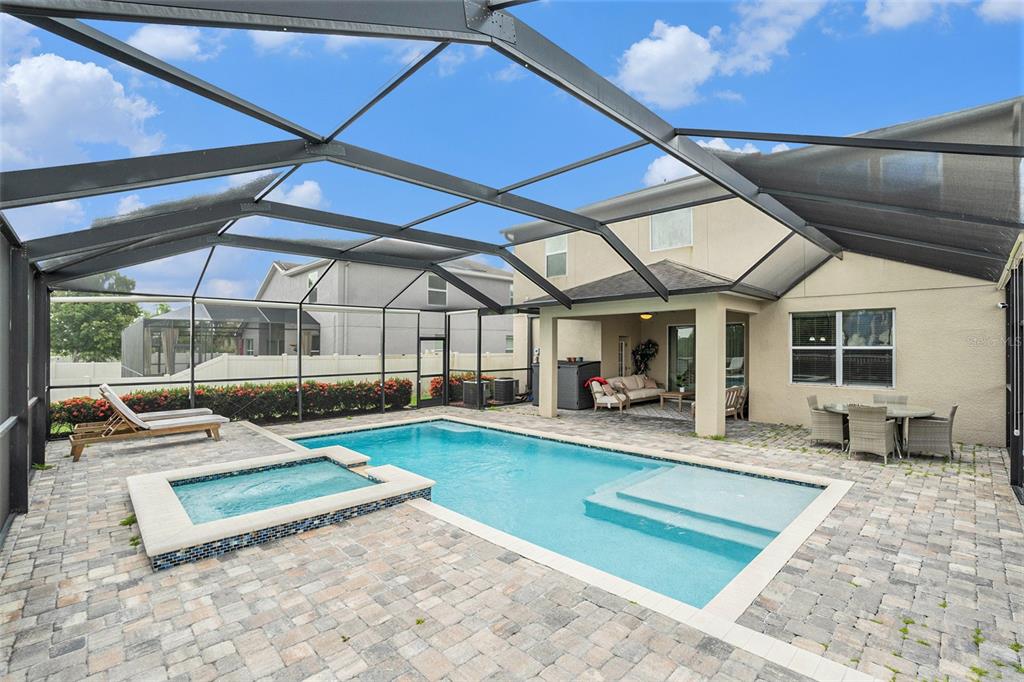 10737 Breaking Rocks Drive Tampa, FL 33647 - Photo 26 of 28 a view of a backyard with table and chairs under an umbrella