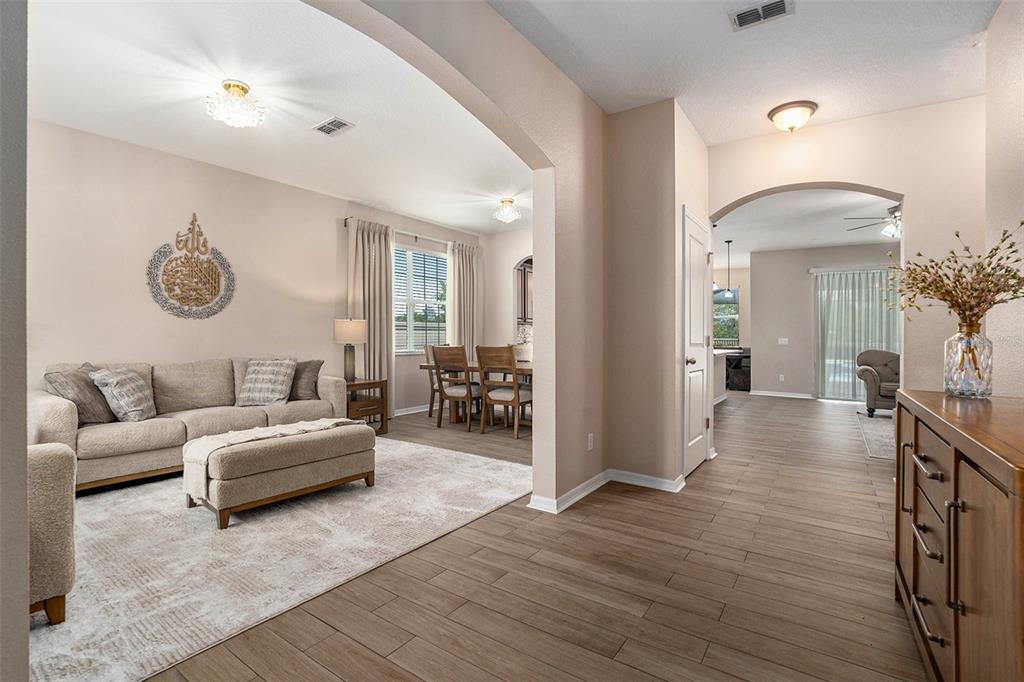 10737 Breaking Rocks Drive Tampa, FL 33647 - Photo 4 of 28 a living room with furniture and a wooden floor