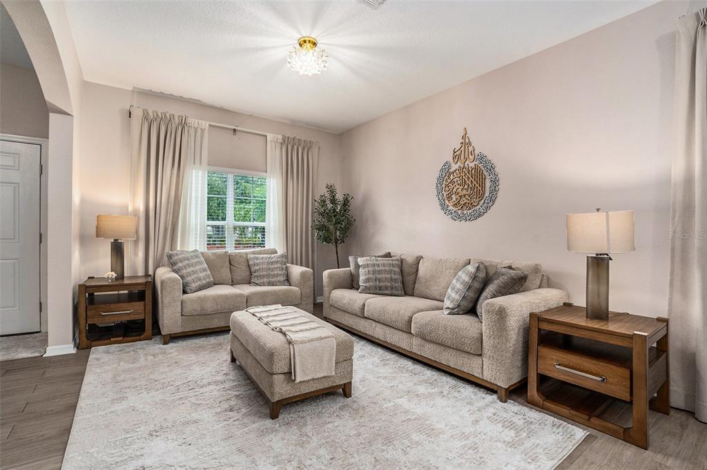 10737 Breaking Rocks Drive Tampa, FL 33647 - Photo 5 of 28 a living room with furniture a couch and a window