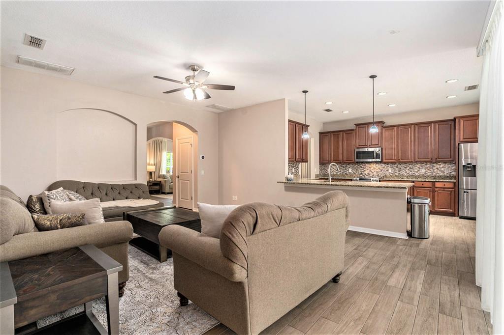 10737 Breaking Rocks Drive Tampa, FL 33647 - Photo 8 of 28 a living room with furniture kitchen view and a chandelier