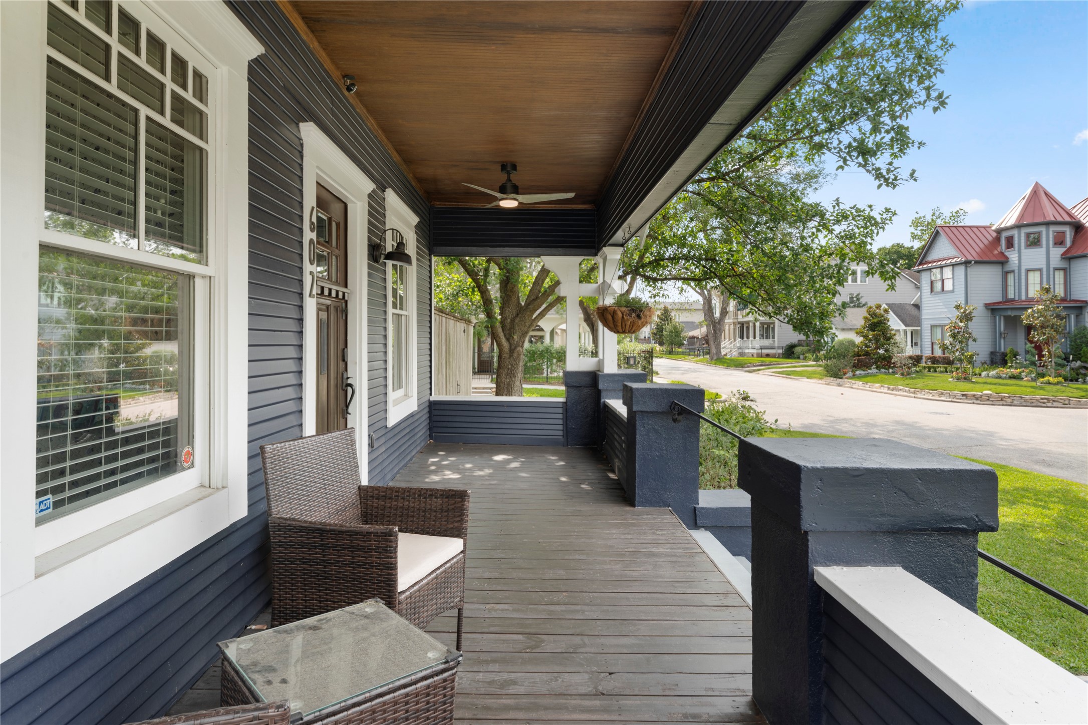 602 Aurora Street Houston, TX 77008 - Photo 5 of 36 Covered front porch with extended depth and space for seating, creating a comfortable outdoor living area. Fanimation TriAire ceiling fans are integrated overhead, adding both function and a subtle design element. Positioned to take in the surrounding streetscape, this space connects the home to the character of the neighborhood.