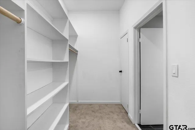 a view of an empty walk in closet