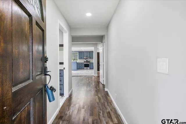 a view of a hallway with wooden floor