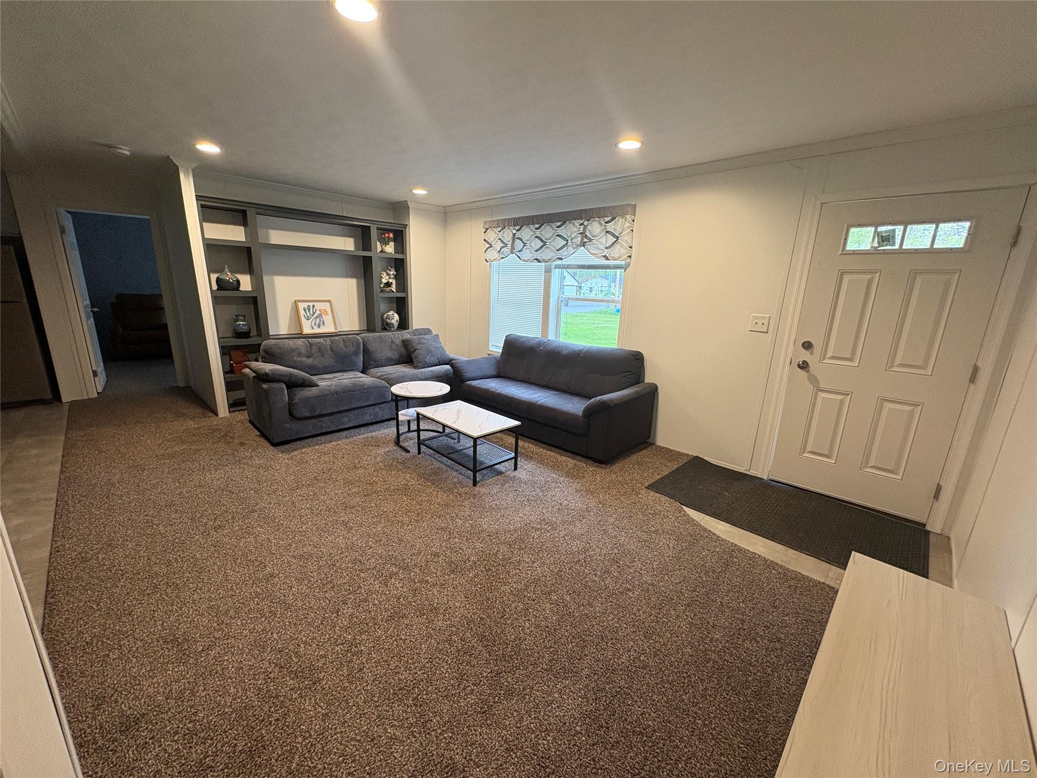 40 4th Street Godeffroy, NY 12729 - Photo 9 of 17 Open-concept living area with modern finishes and furnished seating.