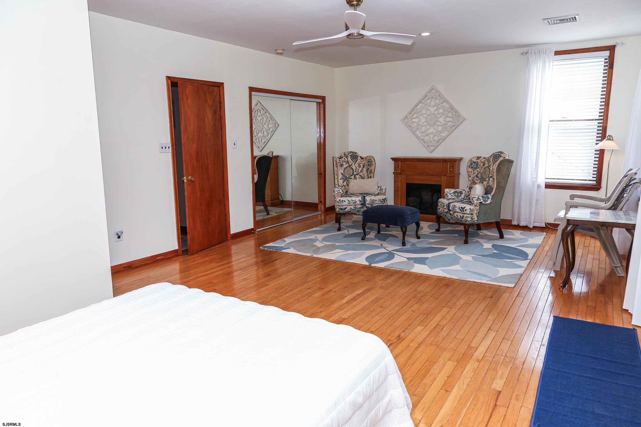 243 6th Street South Brigantine, NJ 08203 - Photo 21 of 28 a living room with a dining table and a fireplace