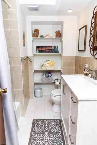 a bathroom with a sink a toilet and a shower