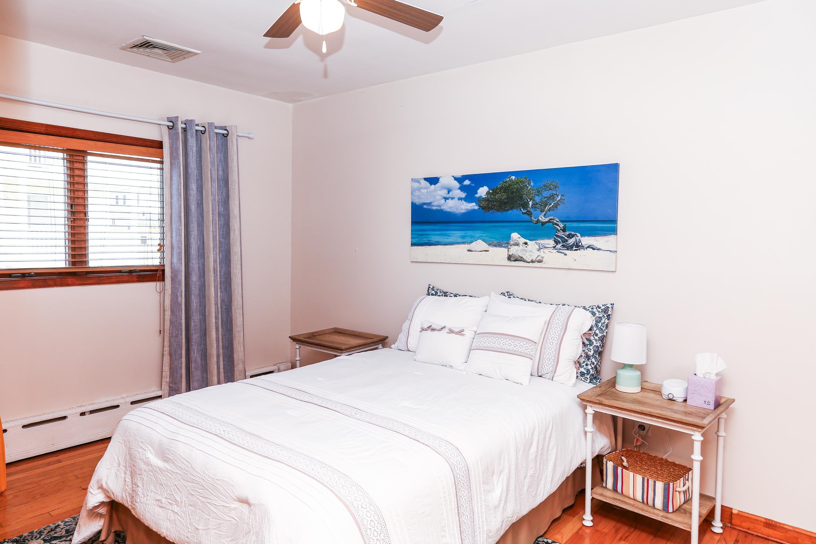243 6th Street South Brigantine, NJ 08203 - Photo 22 of 28 a bedroom with a bed and a chandelier