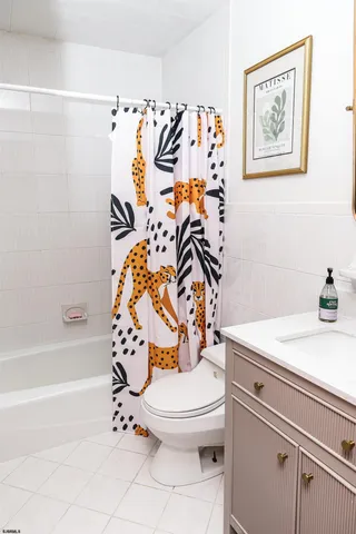 a bathroom with a toilet and a shower curtain