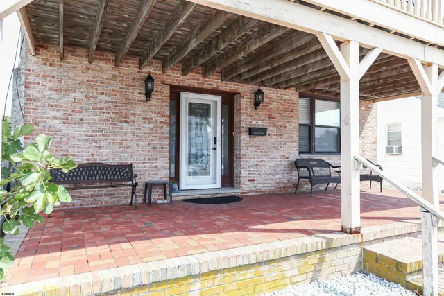 a front view of a house with outdoor seating