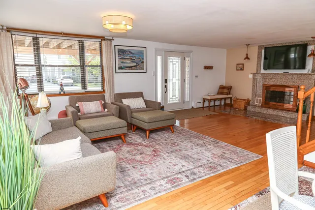 a living room with furniture a flat screen tv and a fireplace