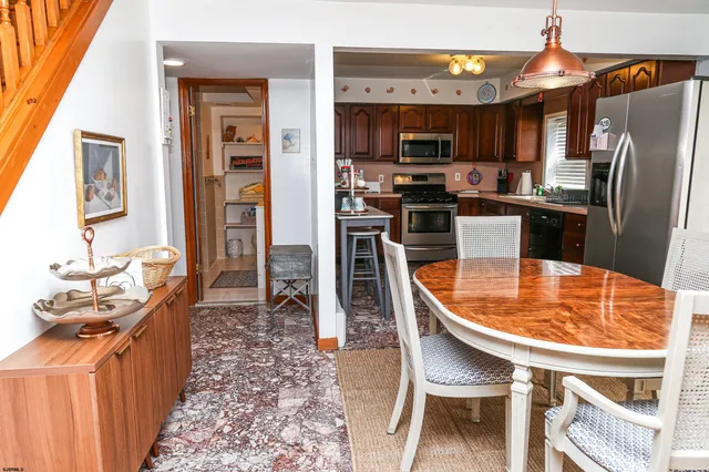 a kitchen with stainless steel appliances granite countertop a sink a stove and refrigerator