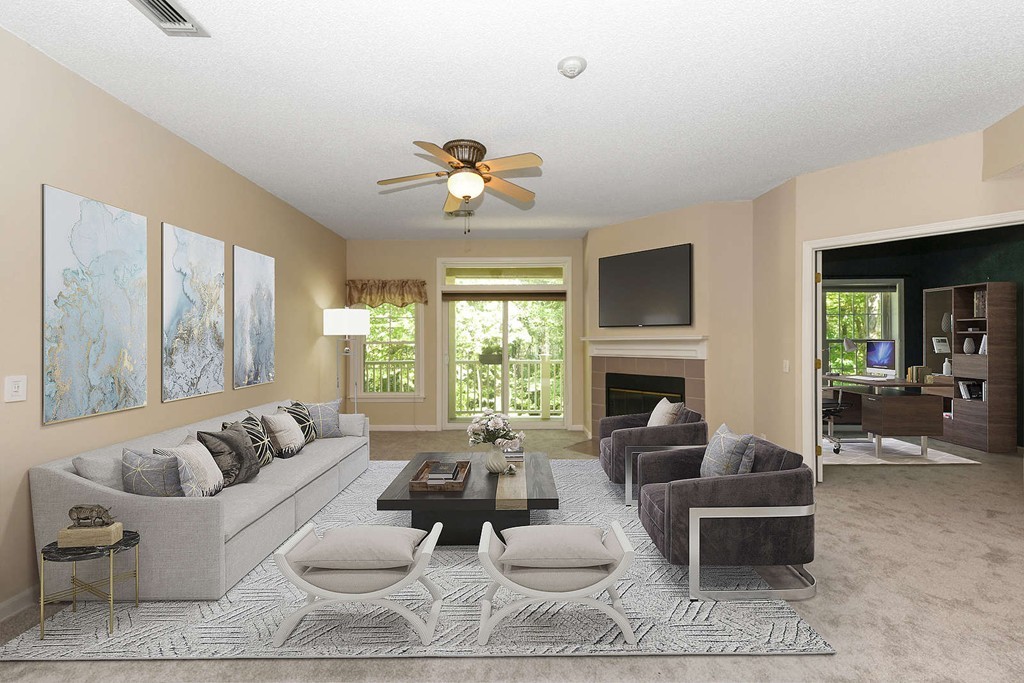 a living room with furniture fireplace and a large window