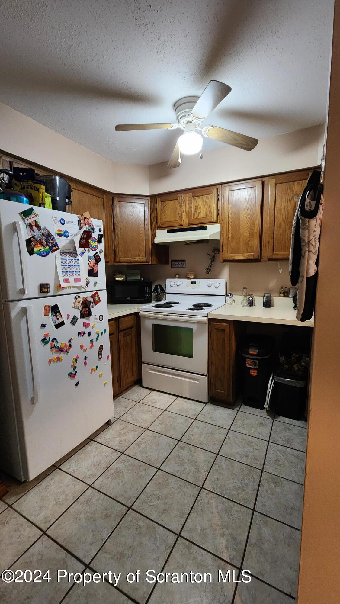 633 Meshopany Ridge Road Meshoppen, PA 18630 - Photo 14 of 41 a kitchen with stainless steel appliances a stove a sink and a refrigerator
