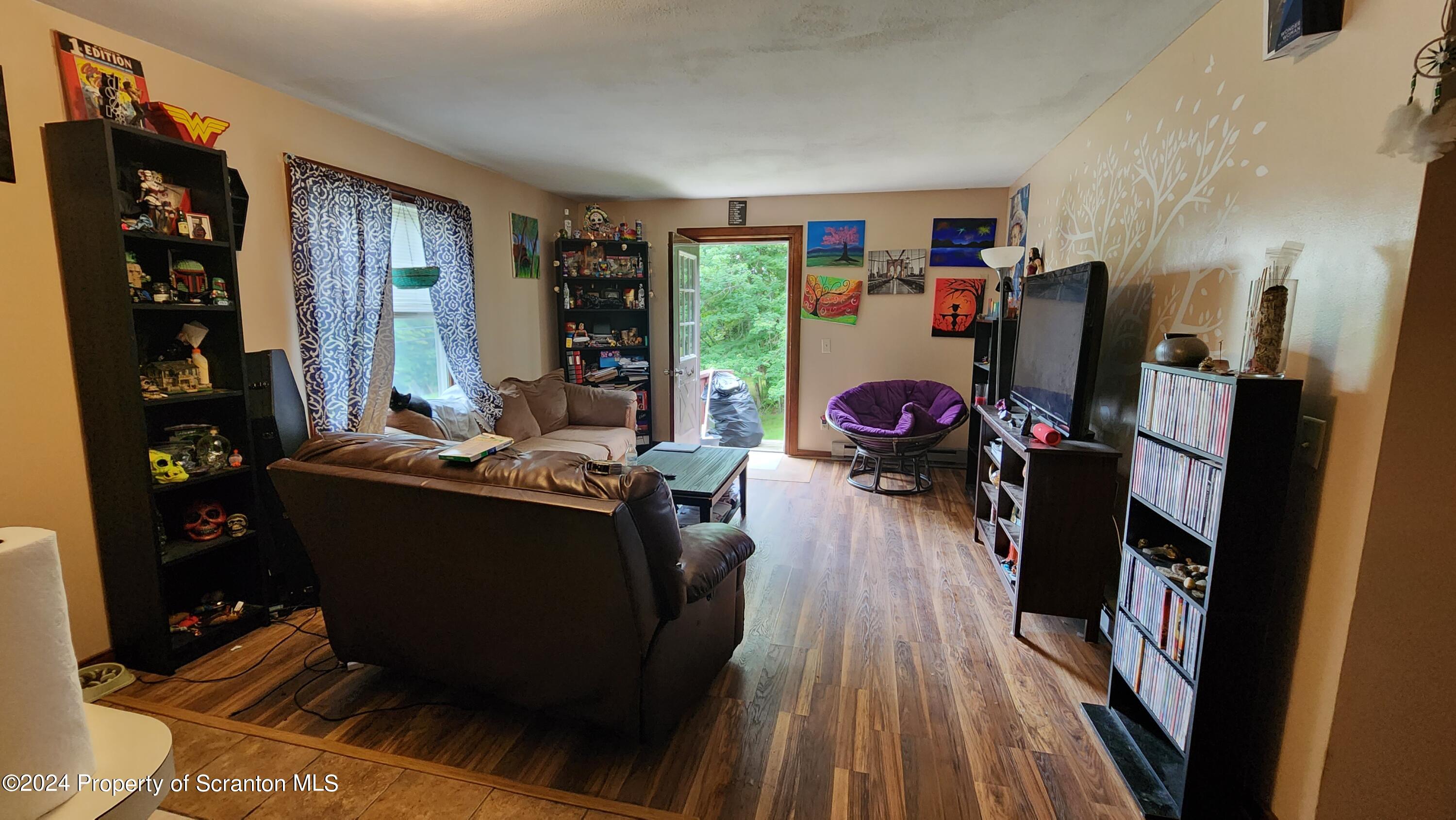 633 Meshopany Ridge Road Meshoppen, PA 18630 - Photo 20 of 41 a living room with furniture and a flat screen tv