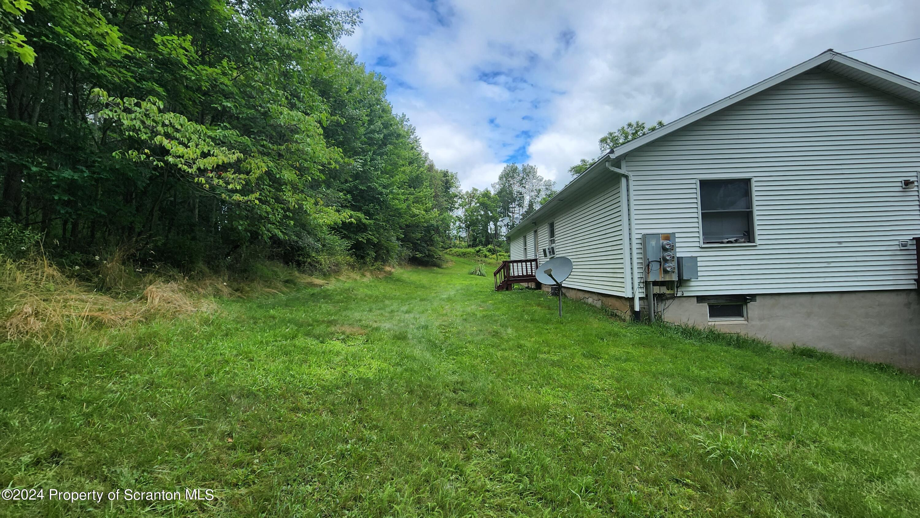 633 Meshopany Ridge Road Meshoppen, PA 18630 - Photo 28 of 41 a front view of house with yard and green space