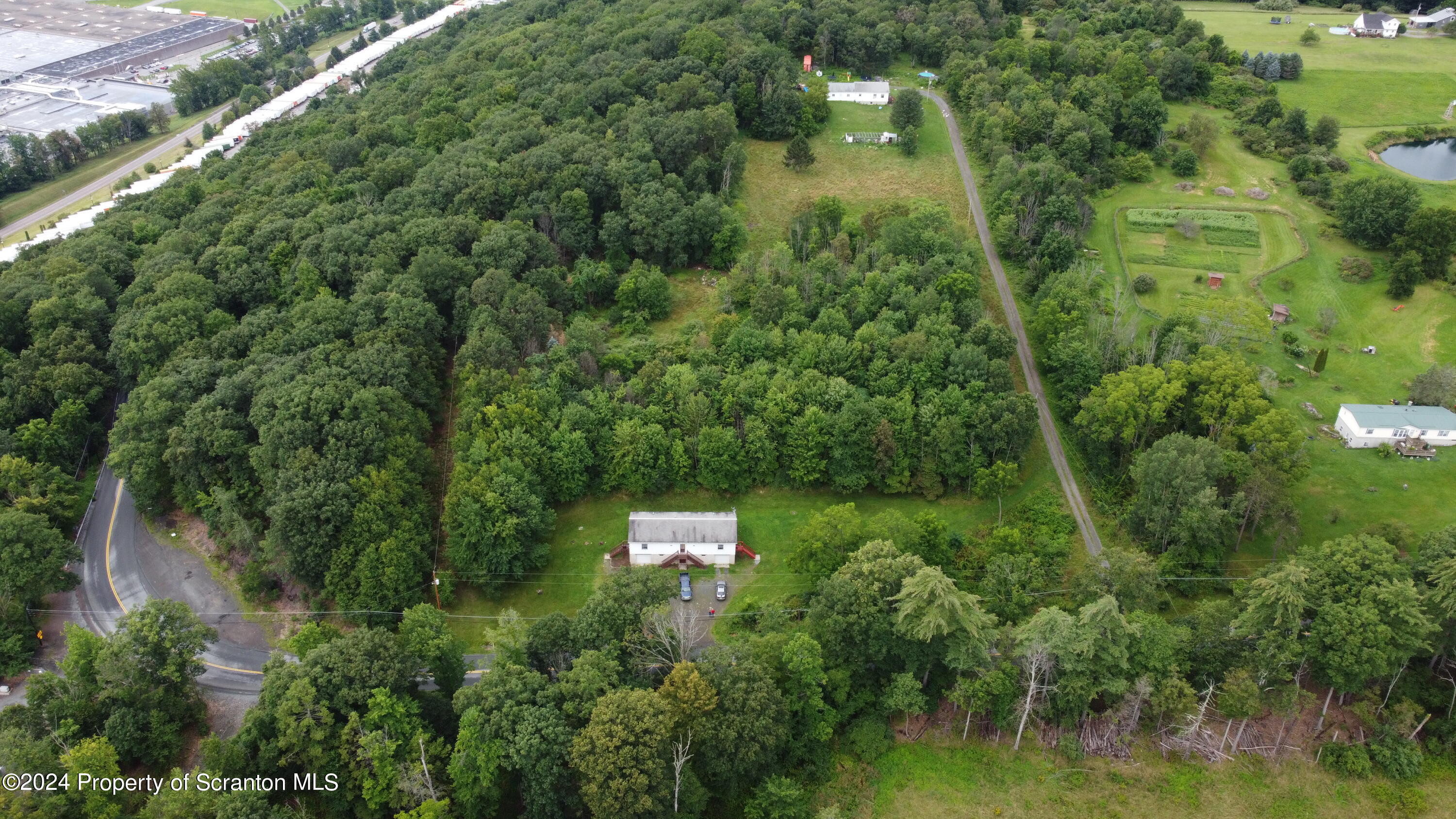 633 Meshopany Ridge Road Meshoppen, PA 18630 - Photo 34 of 41 an aerial view of residential house with outdoor space and trees all around