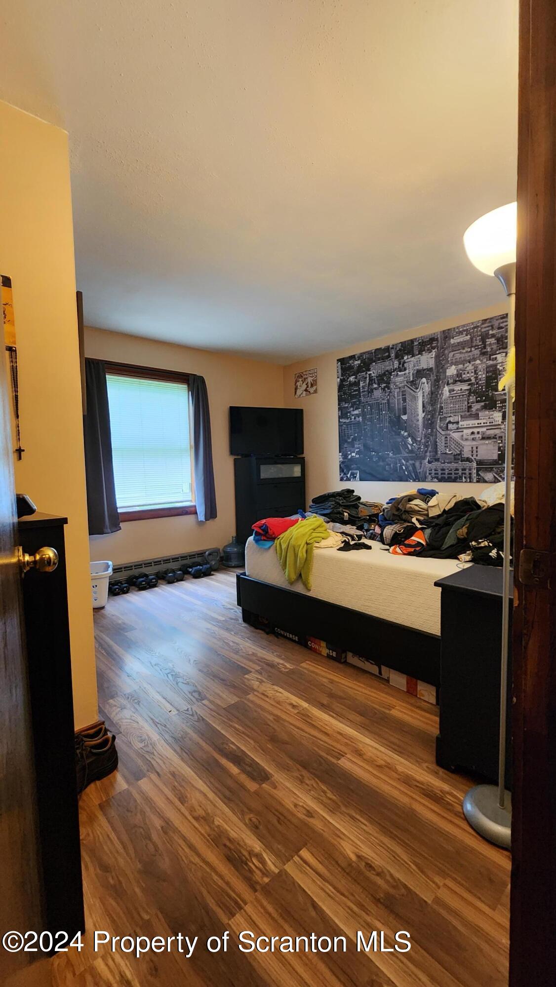 633 Meshopany Ridge Road Meshoppen, PA 18630 - Photo 4 of 41 a bedroom with a bed and wooden floor