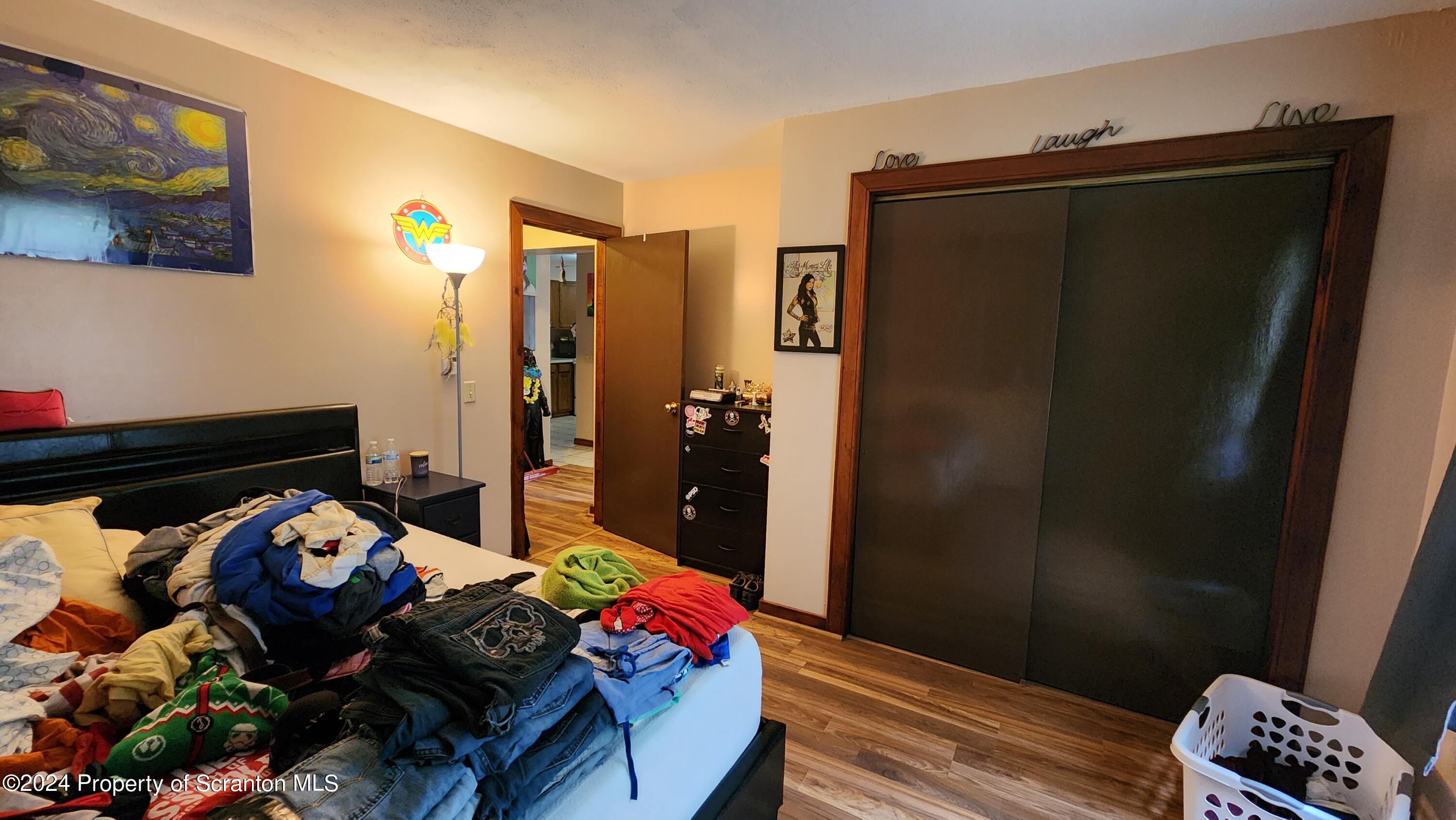 633 Meshopany Ridge Road Meshoppen, PA 18630 - Photo 7 of 41 a bedroom with a bed and wooden floor