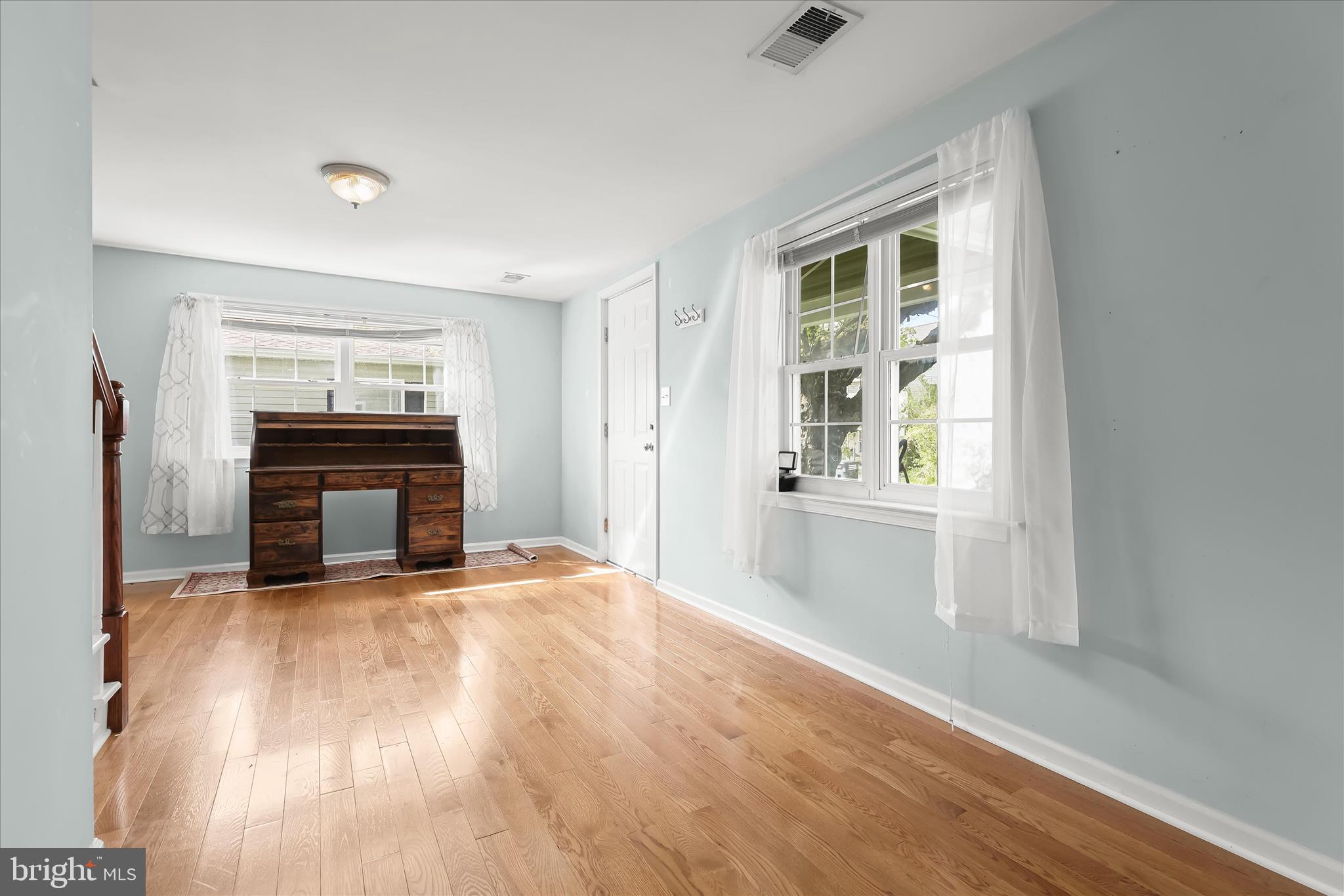 207 Mechanics Valley Road North East, MD 21901 - Photo 12 of 32 a view of an empty room with wooden floor fireplace and a window