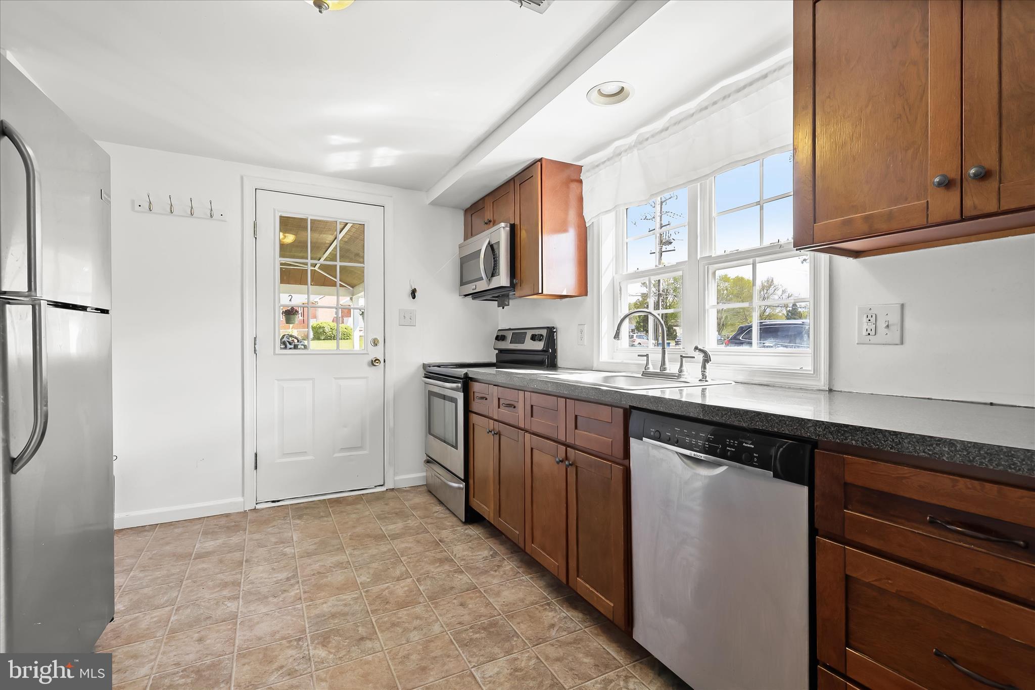 207 Mechanics Valley Road North East, MD 21901 - Photo 15 of 32 a kitchen with stainless steel appliances granite countertop a refrigerator and a sink