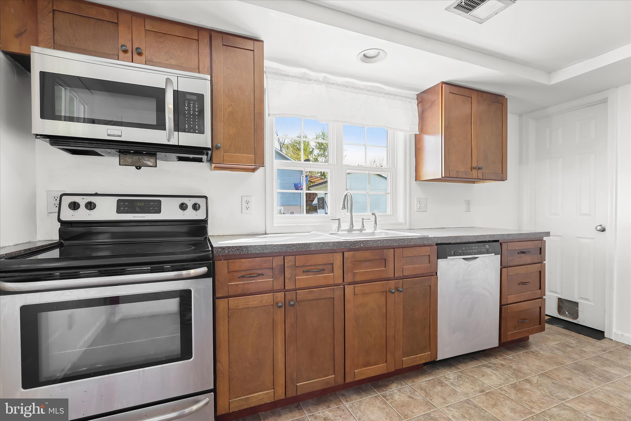 207 Mechanics Valley Road North East, MD 21901 - Photo 16 of 32 a kitchen with stainless steel appliances a stove microwave and sink