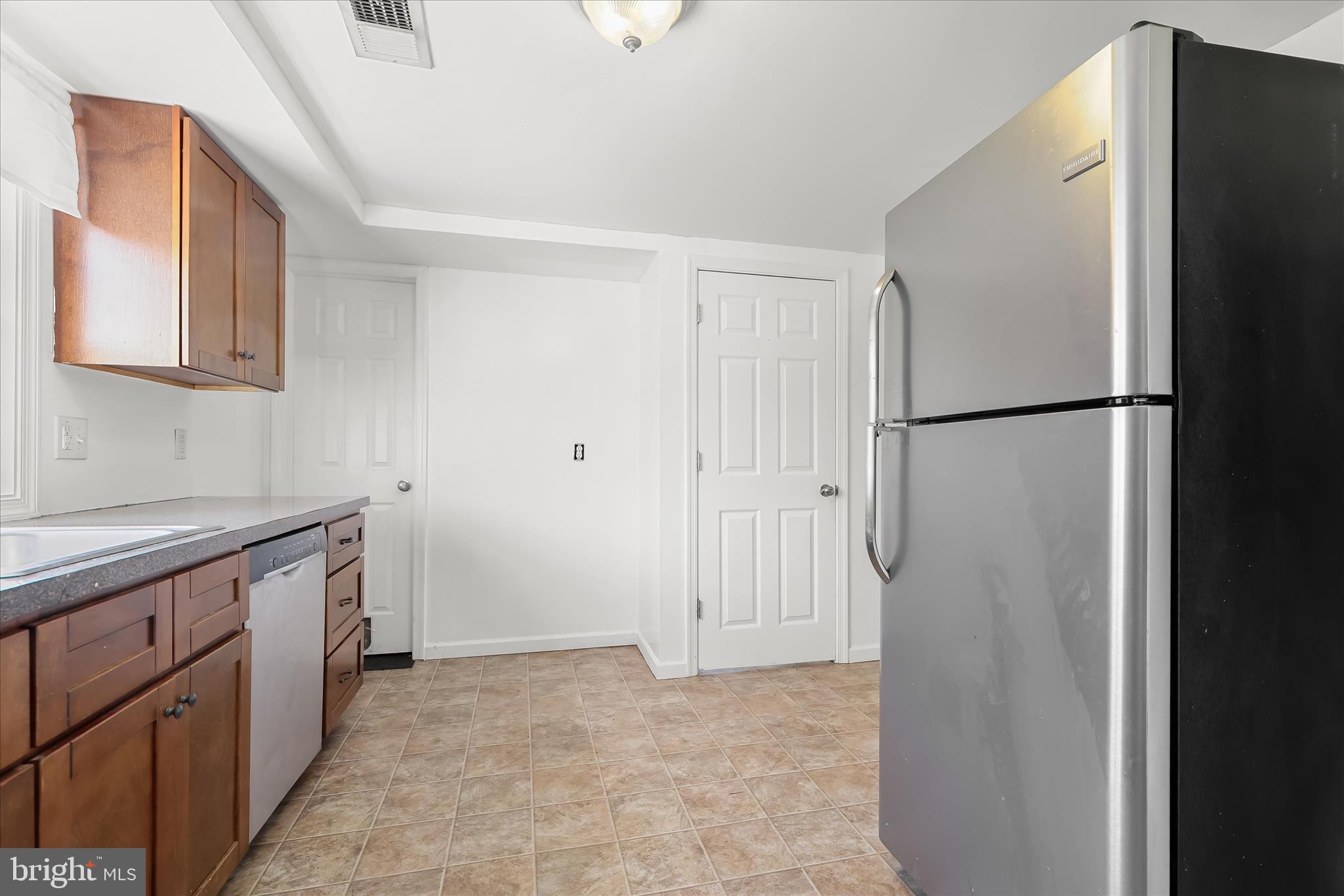 207 Mechanics Valley Road North East, MD 21901 - Photo 17 of 32 a kitchen with a refrigerator and a sink