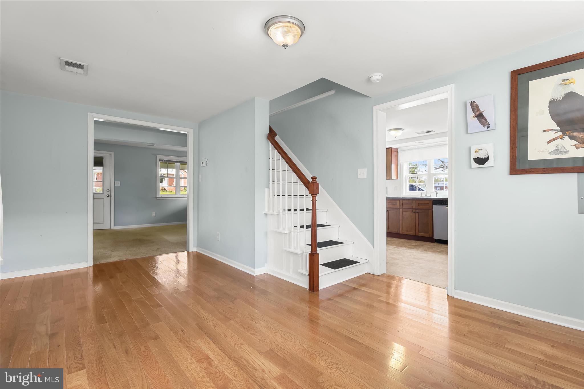 207 Mechanics Valley Road North East, MD 21901 - Photo 10 of 32 a view of a hallway with wooden floor and staircase