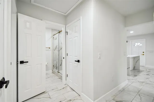 an empty room with wooden floor ceiling fan and windows