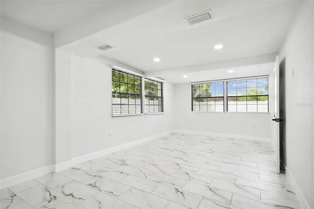 a bathroom with a double vanity sink mirror and toilet