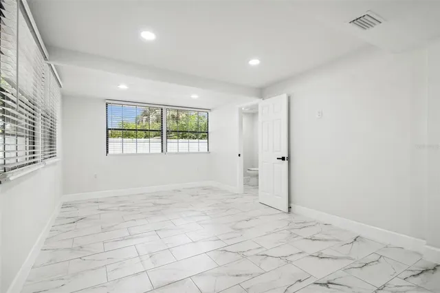 a bathroom with a double vanity sink mirror and toilet