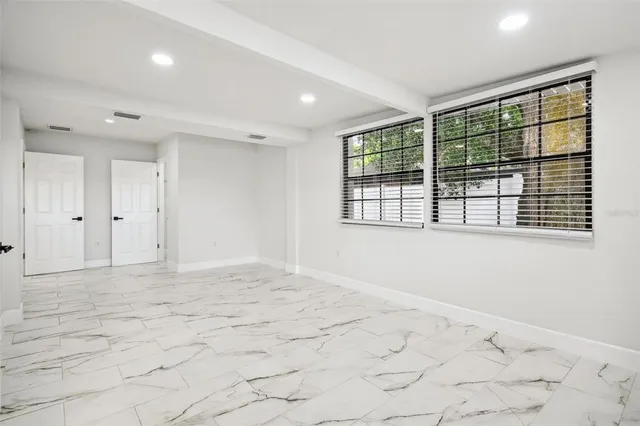 a kitchen with stainless steel appliances granite countertop a sink a stove and a refrigerator