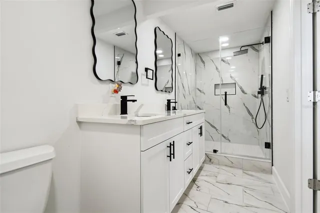 a large kitchen with stainless steel appliances a refrigerator and a stove top oven