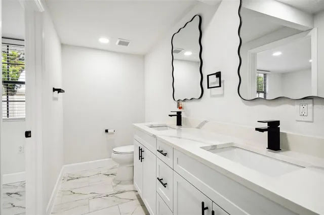 a kitchen with stainless steel appliances a refrigerator sink and stove