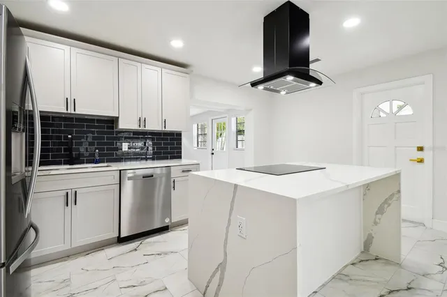 a kitchen with a sink and chandelier