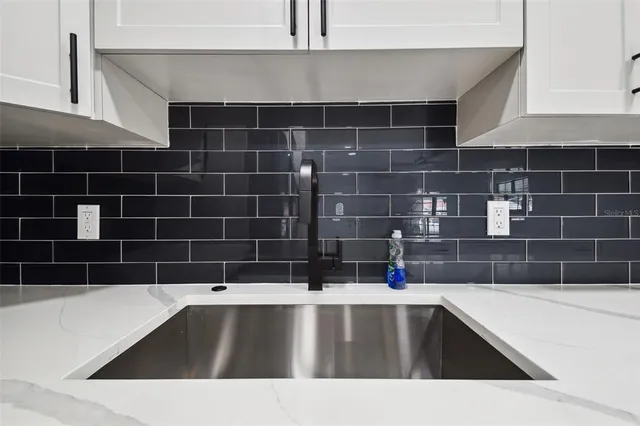 a view of an empty room with window and fire place