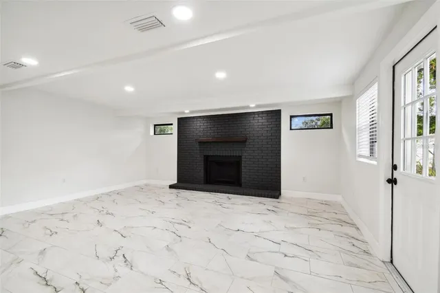 a view of a house with a yard and large tree