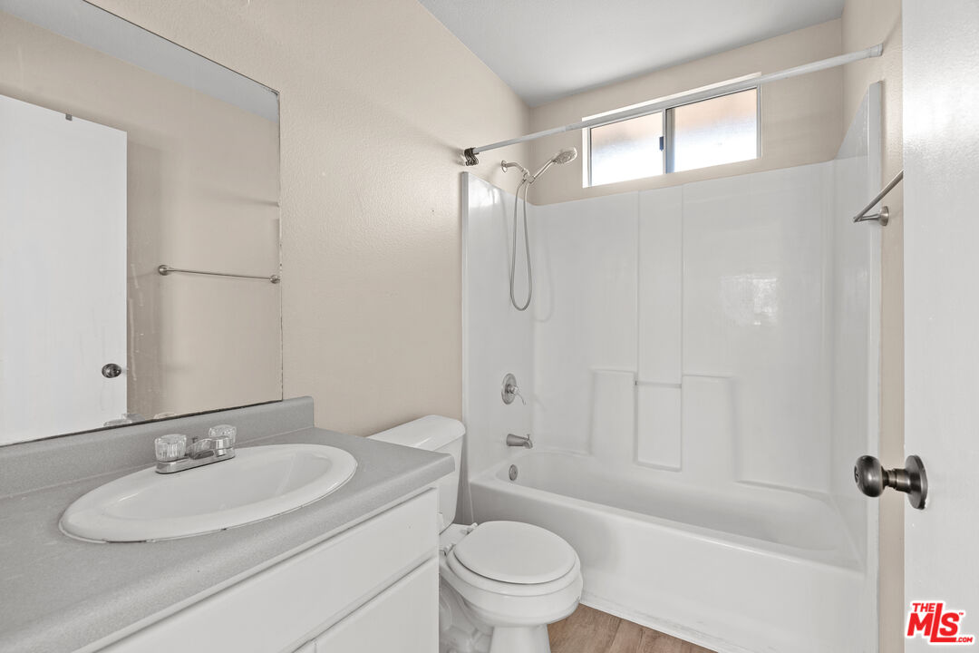 4508 Apricot Road, Unit B Simi Valley, CA 93063 - Photo 11 of 17 a bathroom with a granite countertop sink toilet mirror and shower