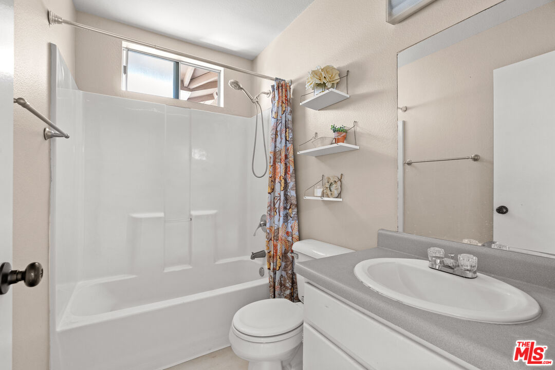 4508 Apricot Road, Unit B Simi Valley, CA 93063 - Photo 14 of 17 a bathroom with a granite countertop sink toilet a mirror and shower