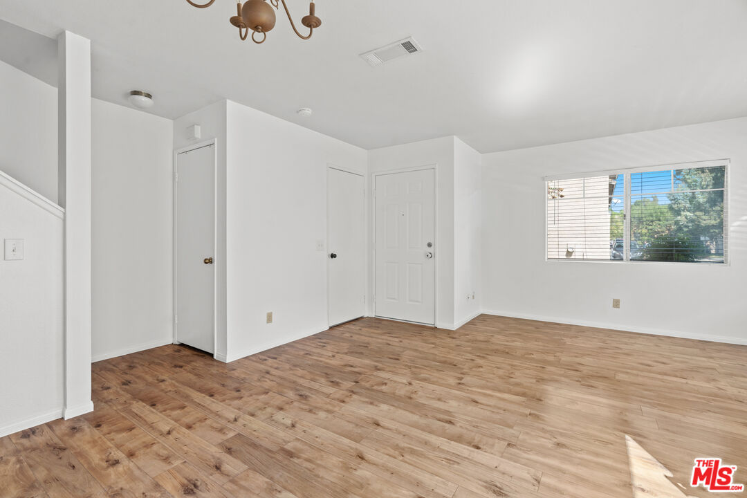 4508 Apricot Road, Unit B Simi Valley, CA 93063 - Photo 4 of 17 a view of an empty room with wooden floor and a window