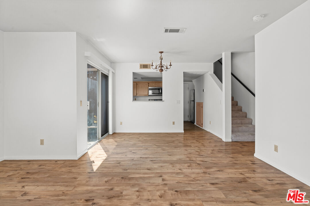 4508 Apricot Road, Unit B Simi Valley, CA 93063 - Photo 6 of 17 a view of a hallway with wooden floor and a refrigerator